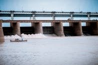 People in Boat Near Water Dam