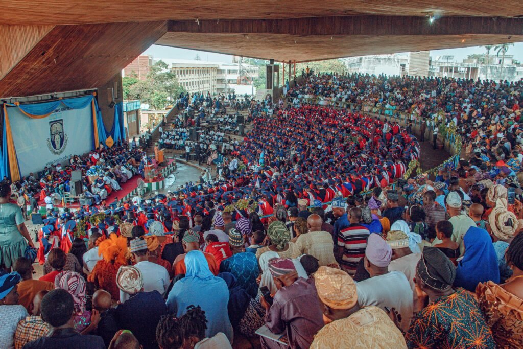 A large crowd of people sitting in a large auditorium