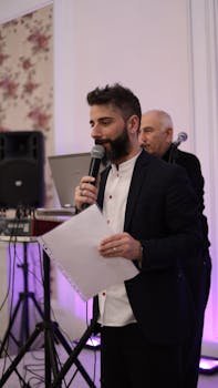 Man in Black Suit While Using Microphone