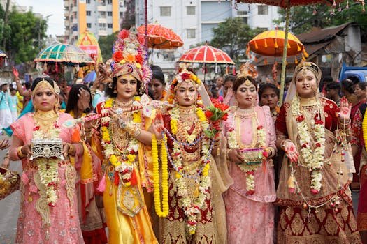 A colorful parade featuring traditional Hindu costumes and decorations during a festival in Dhaka, Bangladesh.